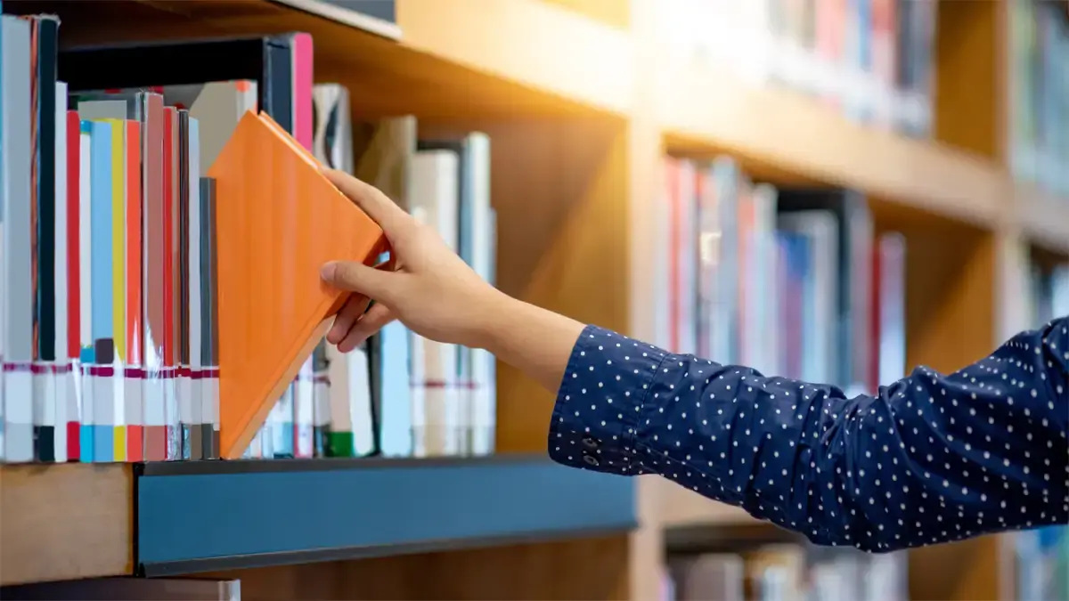 Decorative image for find services of a user grabbing a book of a shelf