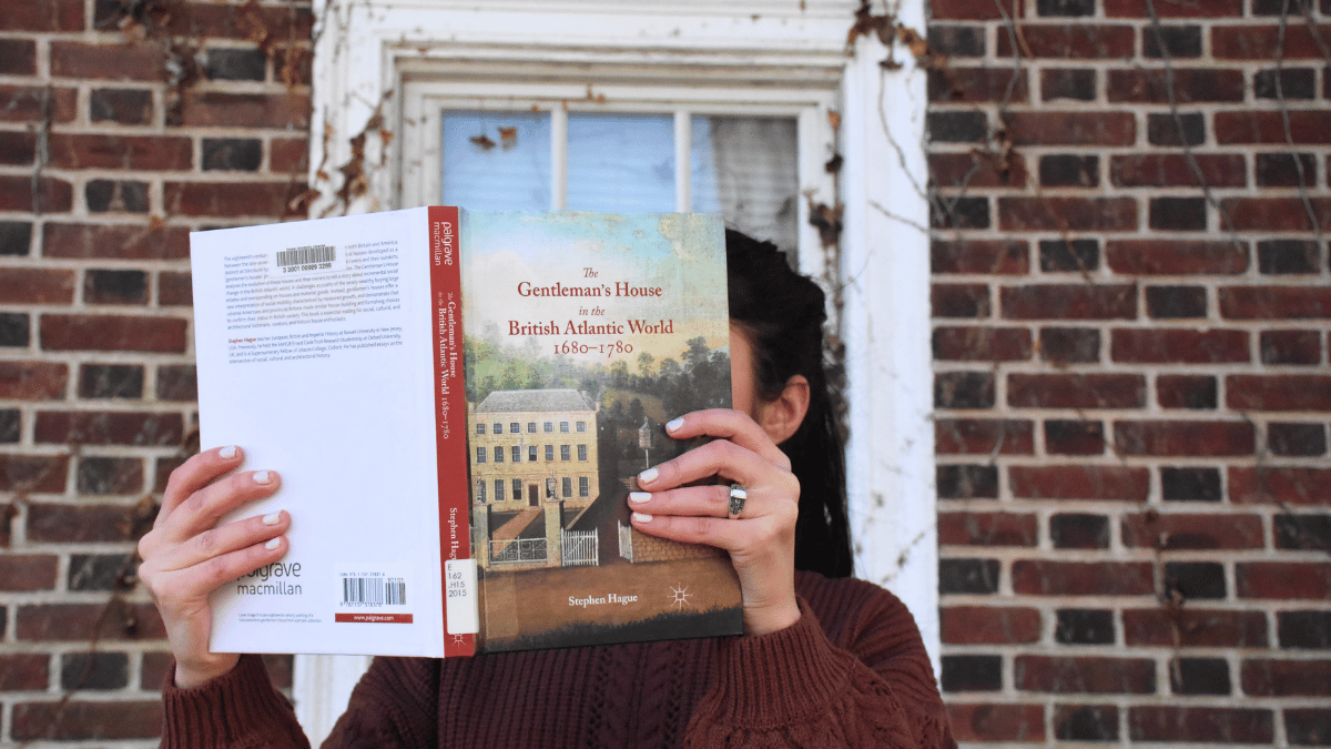 Decorative image of faculty member with a book